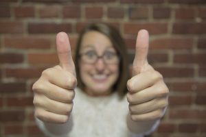 Cheerful lady showing a thumbs up gesture