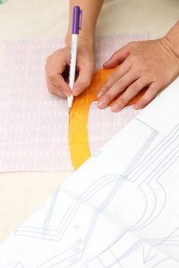 Photograph of a lady using her sewing pattern